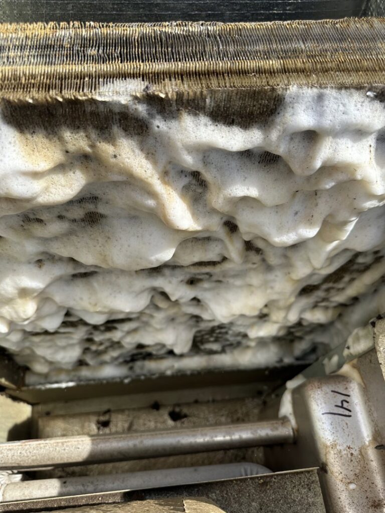 A dirty HVAC coil being cleaned with foam by 32 Degrees Heating and Air Conditioning in Las Vegas, NV
