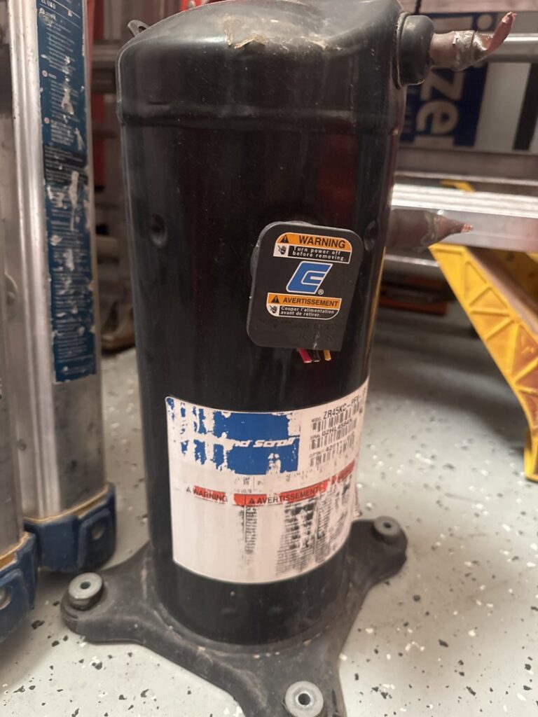 A close-up of an HVAC compressor unit, a key component for Husky Heating and Cooling in Westminster, CO.