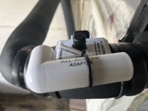 A close-up of an HVAC condensate drain adapter installed by Southwest Florida Air Quality in Cape Coral, FL