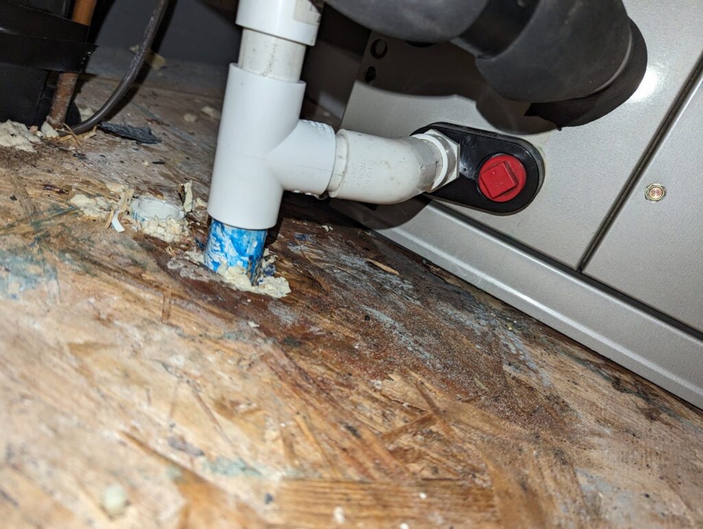 Close-up of a newly installed HVAC condensate drain line and wiring by Zippers Heating and Cooling in Mobile, AL.