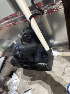 A condensate pump and PVC piping installed for an HVAC system by Advanced Home Services in Rigby, ID.