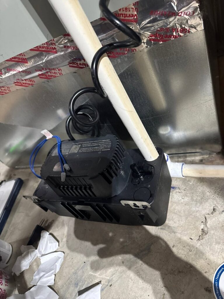 A condensate pump and PVC piping installed for an HVAC system by Advanced Home Services in Rigby, ID.