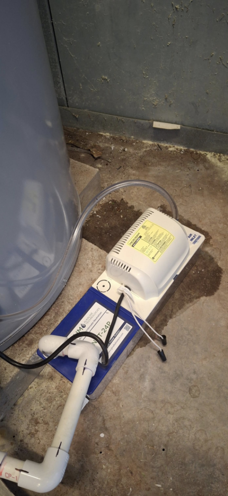 A condensate pump connected to a water heater or boiler, installed by J Hannah Mechanical Inc in Saco, ME.