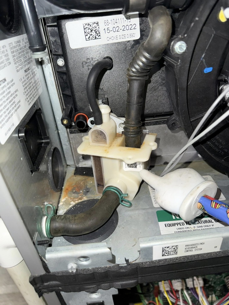 Detailed view of an HVAC condensate pump system serviced by Freedom Heating & Cooling in Lathrop, MO.