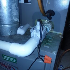 Close-up of a condensate pump and wiring on an indoor HVAC unit serviced by Home Shield Heating and Air in Shreveport, LA.