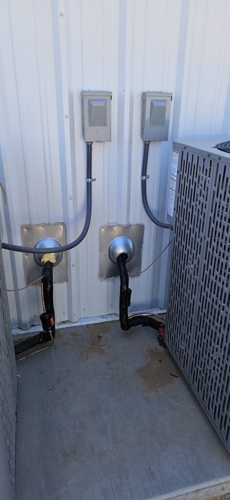 Electrical conduits and refrigerant lines connected to outdoor HVAC condenser units by HoxAir Heating & Cooling in Phoenix, AZ