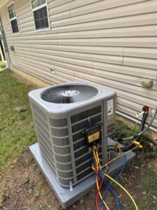 An HVAC technician performing service on an outdoor condenser unit for Sterling Service of Florida Inc in Tallahassee, FL.