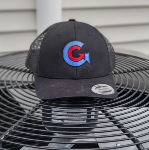 An outdoor HVAC condenser unit with a branded hat on top, showcasing services by Global Sheetmetal Inc in Warwick, RI.