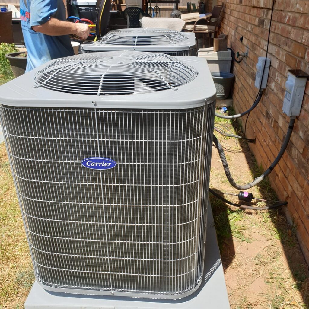 Two outdoor HVAC condenser units being installed or serviced by Home Shield Heating and Air in Shreveport, LA.