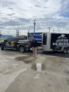 An HVAC contractor's truck and trailer, with a Winsupply trailer in the background, in North Kansas City, MO.