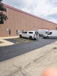 HVAC contractor vans and trucks parked outside Johnstone Supply - Naperville, IL, ready for service calls