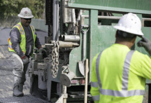 HVAC contractors operating drilling equipment for geothermal loop installation by Environmental Loop Service in Tulsa, OK.