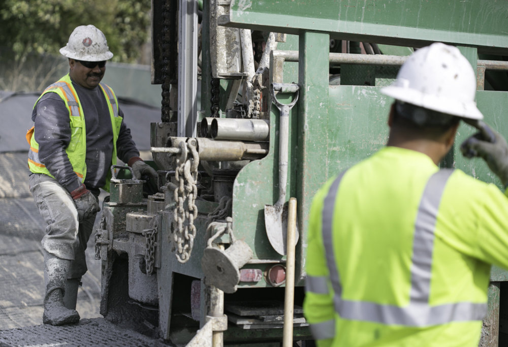 HVAC contractors operating drilling equipment for geothermal loop installation by Environmental Loop Service in Tulsa, OK.