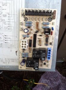 An HVAC control board with its corresponding wiring diagram, indicating diagnostic or repair work by Johnson's Heating and Cooling in Clarksville, TN.