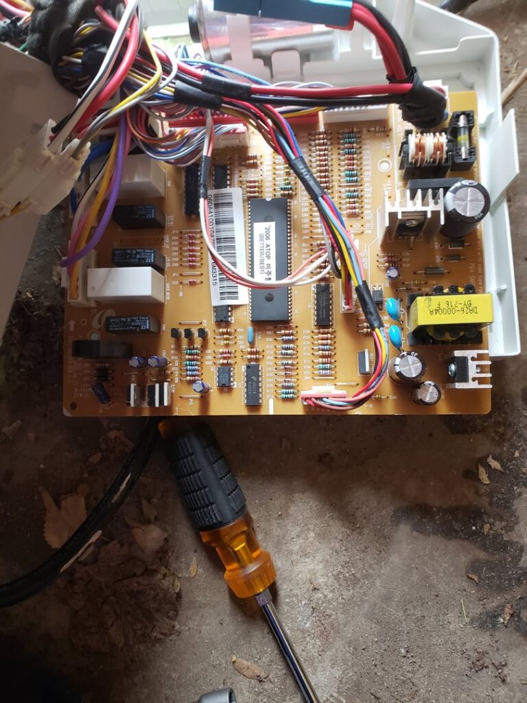 A close-up of an HVAC control board with wiring, indicating repair or diagnostic work by Thin Air Heating & Cooling Repair in Arvada, CO.