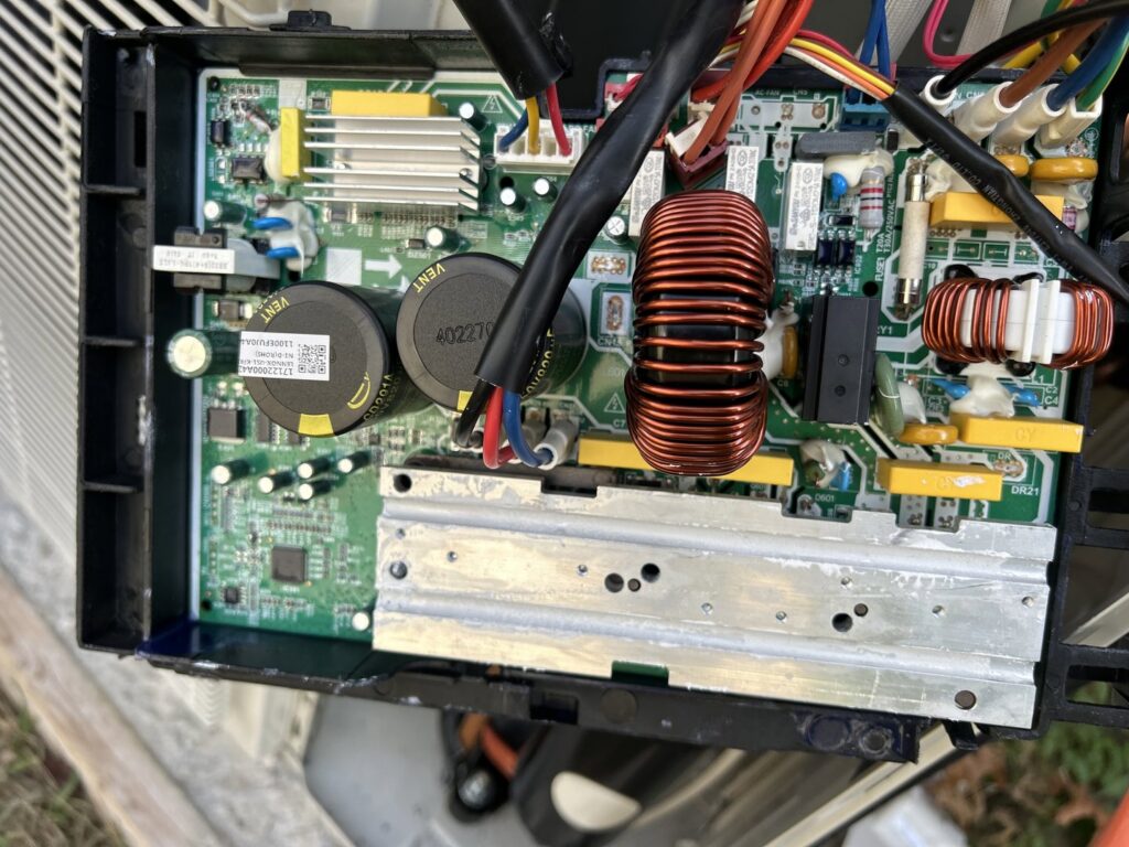 Close-up of an HVAC control board with electronic components, indicating diagnostic or repair work by Underwood Heating and Air Conditioning in Phenix City, AL