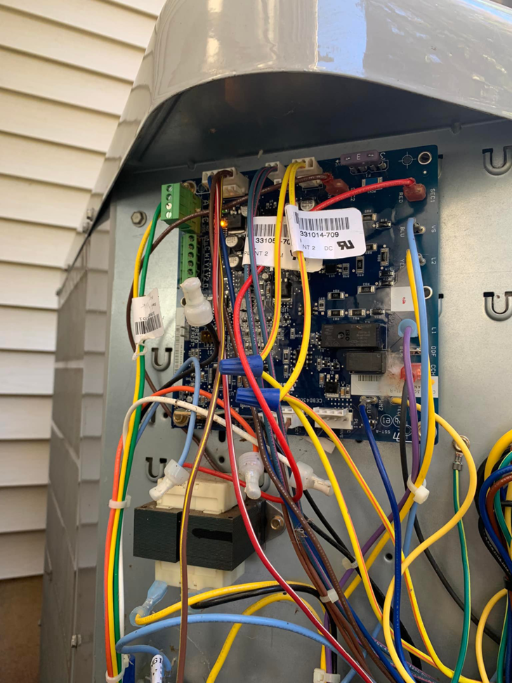 A close-up view of an HVAC control board with intricate wiring, indicating service work by aghapy 1 in Jersey City, NJ