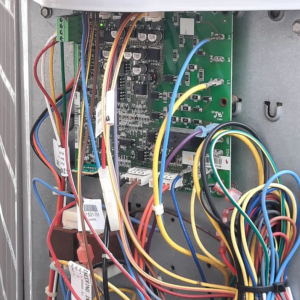 A close-up view of an HVAC control board with colorful wiring, serviced by Trusty Air Conditioning in New Orleans, LA.