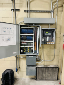 An open HVAC control panel with an air filter on the floor, installed by ICM Mechanical & Controls, LLC in Fall River, MA