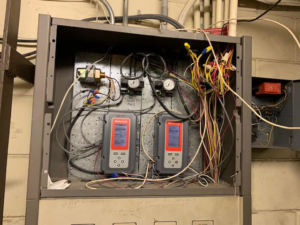 An open HVAC control panel featuring Honeywell controllers and wiring by Allstate Heating & Cooling in Lexington, KY.