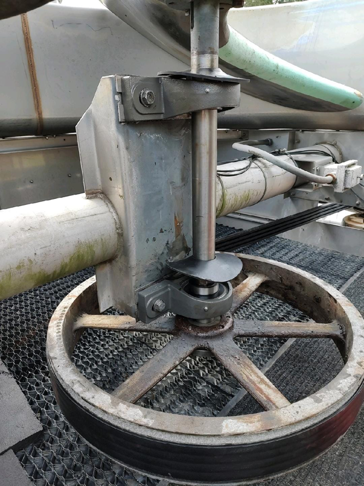 Close-up of a heavy-duty pulley and shaft system for an HVAC cooling tower, serviced by CMC Mechanical in Goose Creek, SC.