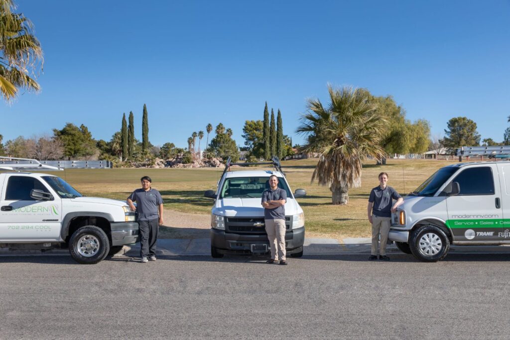 Modern Air Conditioning & Heating crew standing with their service fleet of vehicles in Boulder City, NV.