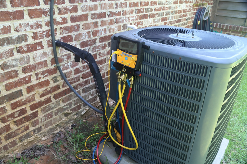 HVAC diagnostic equipment connected to an outdoor AC unit during service by Southside Energy in Chesapeake, VA.