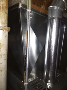 Close-up of HVAC duct and pipe connections during an installation by PM Construction in Loves Park, IL.