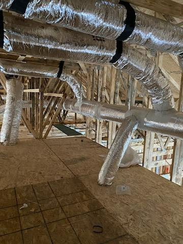 A technician's hand holding a smartphone displaying an image from a duct inspection camera, used by American Air Solutions in Summerville, SC.