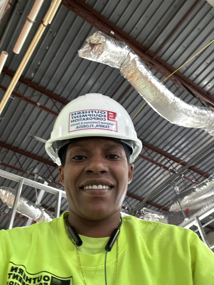 A Southern Equipment Corporation worker with installed HVAC ductwork in the background in Tampa, FL