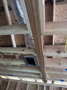 A close-up of an HVAC duct register opening in a wooden ceiling frame by Comfort Temp HVAC LLC in Fort Smith, AR