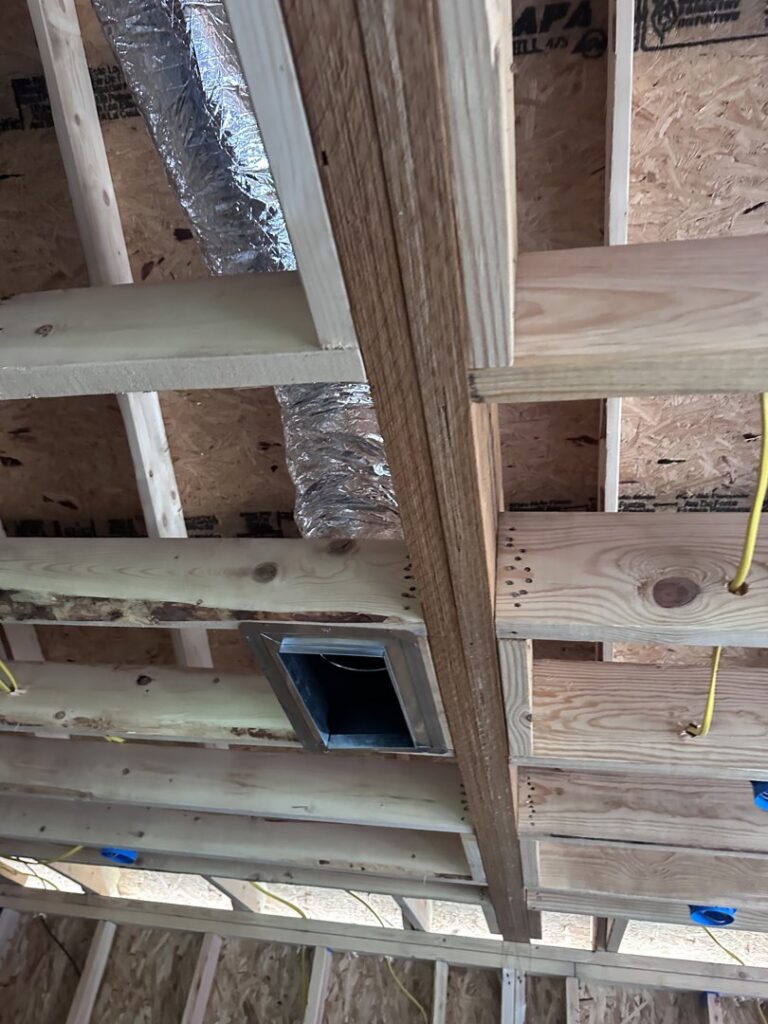 A close-up of an HVAC duct register opening in a wooden ceiling frame by Comfort Temp HVAC LLC in Fort Smith, AR