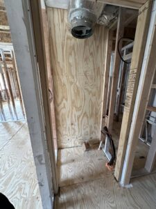An HVAC duct rough-in in a framed wall during new construction by Federal Heating & Cooling in Dresden, OH.