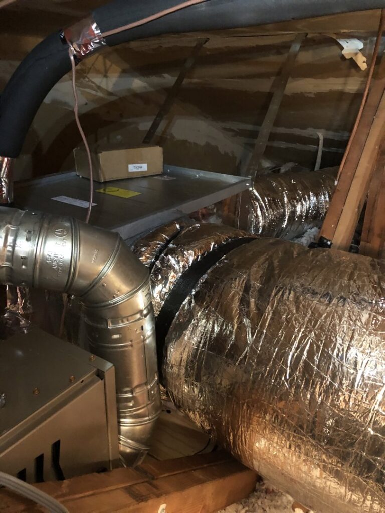 HVAC ductwork and an air handler unit visible in an attic space, installed by Peace & Comfort Heating and Air in San Diego, CA.