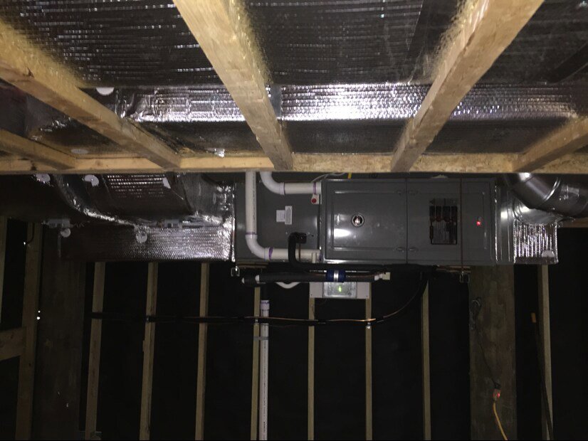HVAC ductwork and an air handler unit installed in a ceiling space by Accurate Conditioning in Sayreville, NJ.