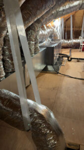 Extensive HVAC ductwork and an air handler unit installed in an attic by Moreau's Heating & AC in Lake Charles, LA.