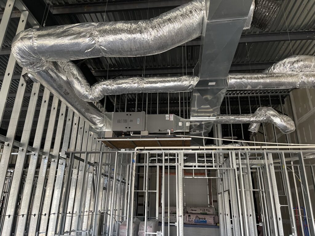 HVAC ductwork and air handler installation in a building under construction by Fayette Plumbing & HVAC in Lexington, KY.