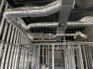 HVAC ductwork and air handler installation in a building under construction by Fayette Plumbing & HVAC in Lexington, KY.