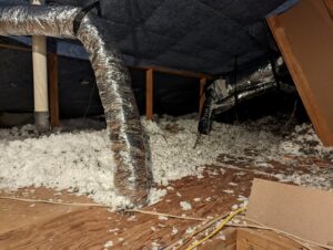 HVAC ductwork and insulation visible in an attic, representing work by Airtegrity Comfort Solutions in San Antonio, TX