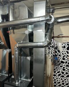 Complex metal HVAC ductwork and piping installed in a utility area by Deboque Duct Design Corp. in Staten Island, NY