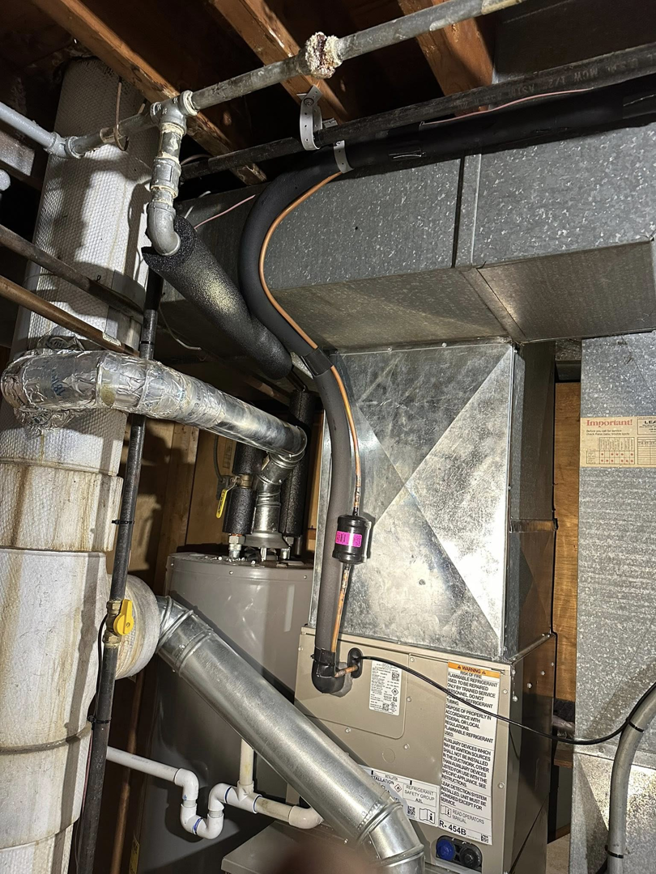 Detailed view of HVAC ductwork and piping installation by F&S Heating And Cooling in Elgin, IL.