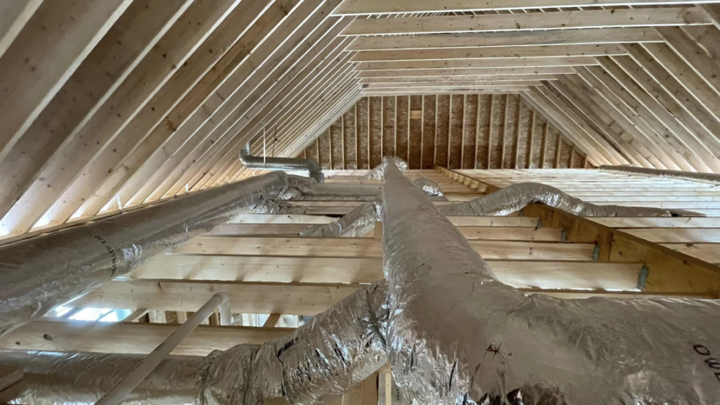 View looking up at HVAC ductwork installed in an attic ceiling by Paul Mechanical LLC in Merrimack, NH