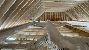 View looking up at HVAC ductwork installed in an attic ceiling by Paul Mechanical LLC in Merrimack, NH