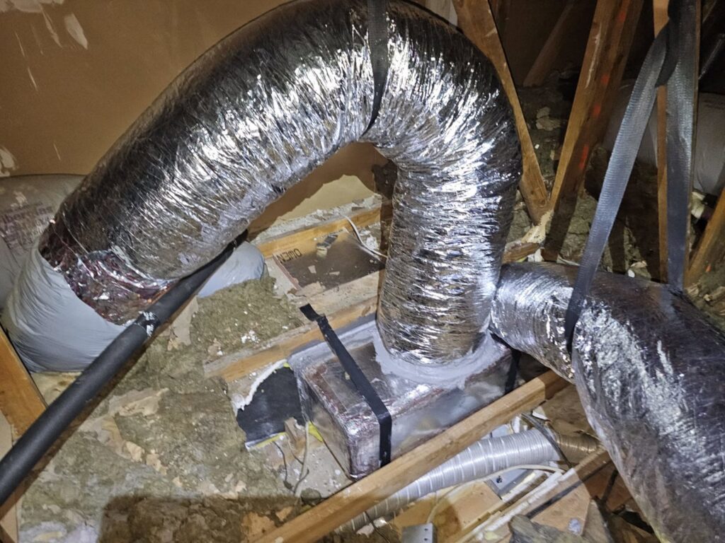 Insulated HVAC ductwork running through an attic space by Manuel & Sons Service Co. in San Antonio, TX.