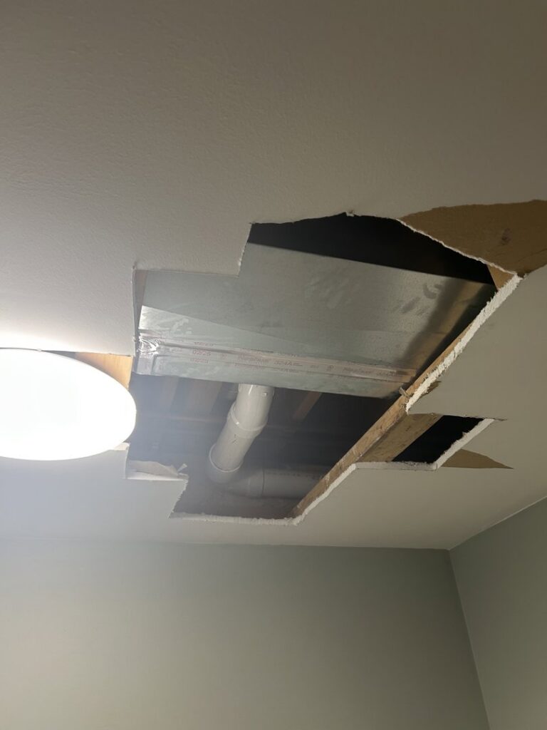 A ceiling opening revealing HVAC ductwork, likely for repair or installation access, by Air For You Heating and Air in Joliet, IL.