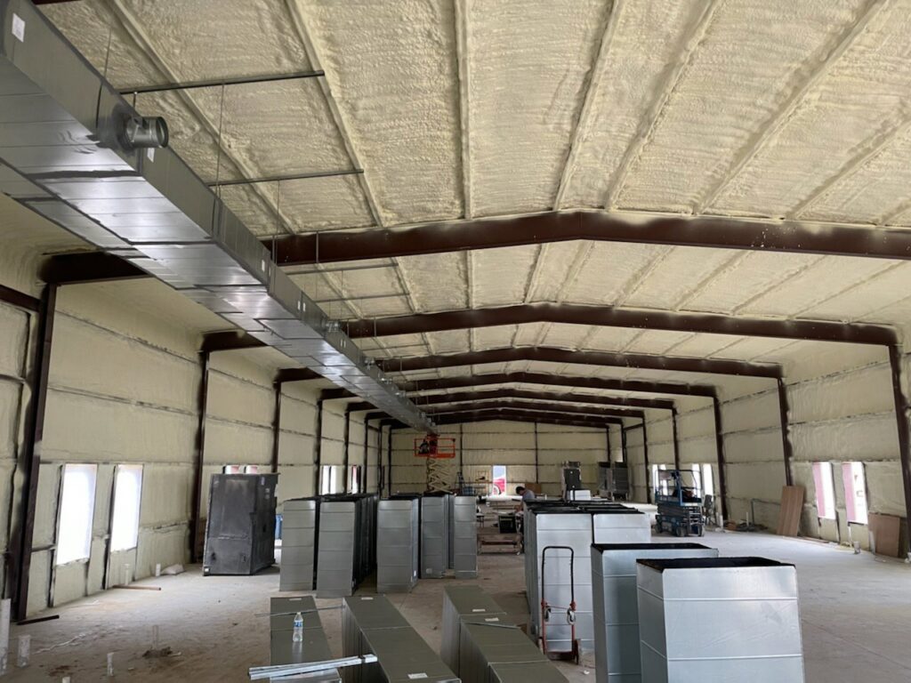 Stacks of metal HVAC ductwork components inside a commercial building by Norway Air Conditioning Inc. in Laredo, TX.