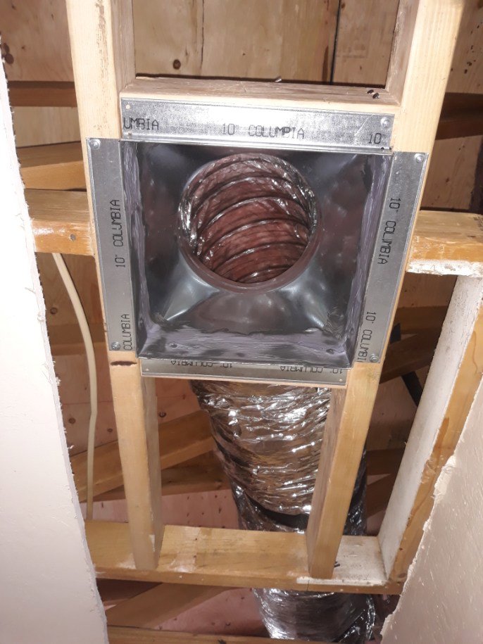 A close-up of an HVAC ductwork connection in a ceiling joist by ABC Mechanical Inc in Lawrenceville, GA.