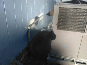 Custom ductwork connecting to an outdoor HVAC unit, installed by NAS Heating & Air for a home in Fayetteville, NC.