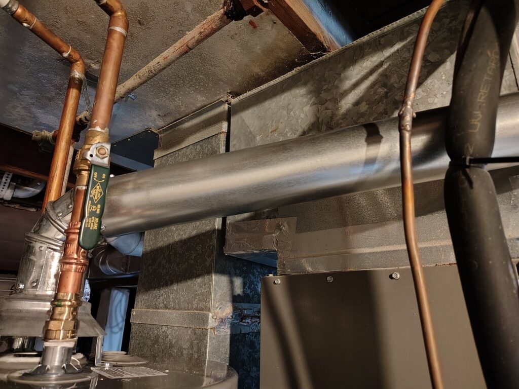 Close-up of HVAC ductwork and copper piping installation by Thrasher Service Corp in Des Moines, IA.