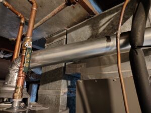 Close-up of HVAC ductwork and copper piping installation by Thrasher Service Corp in Des Moines, IA.